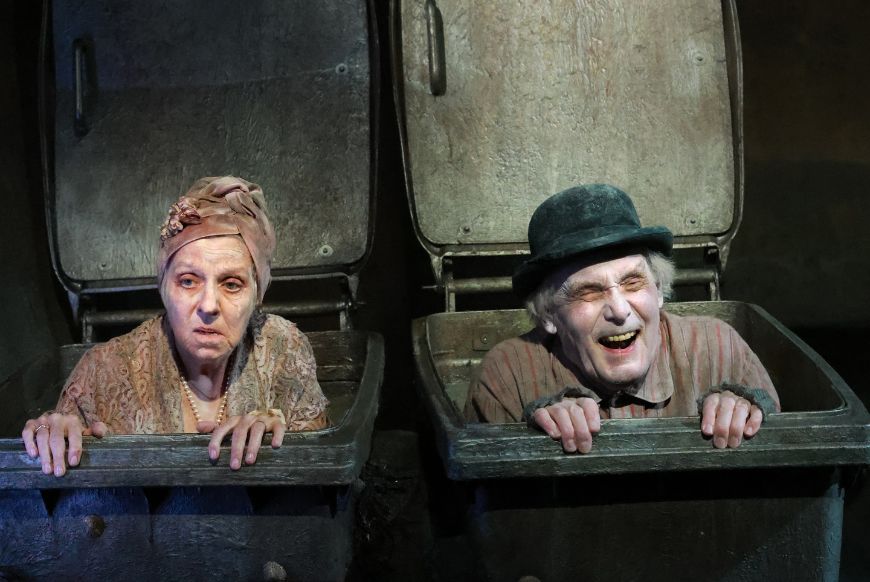 two people coming out of wheelie bins